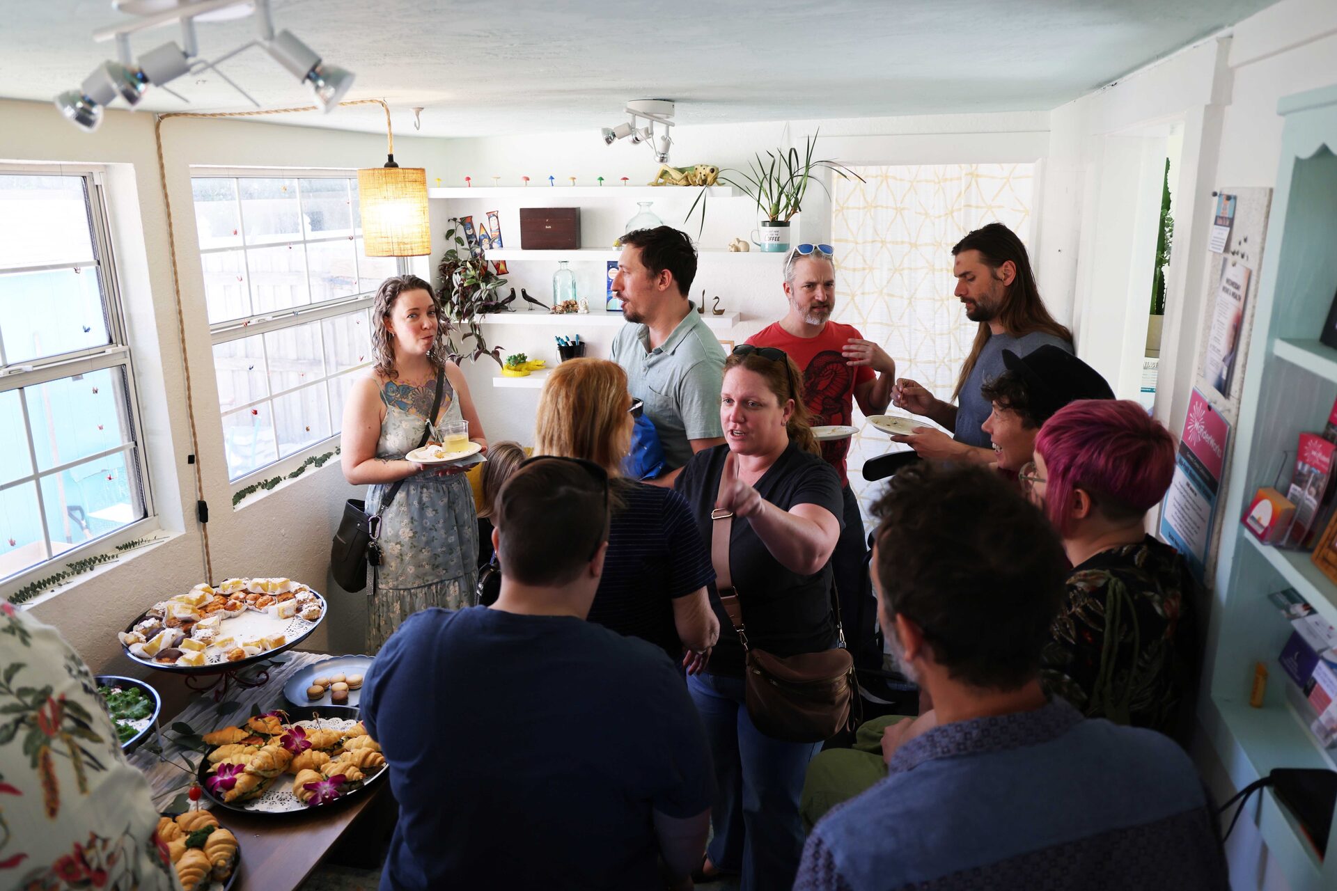 Guests mingling and enjoying appetizers together at a baby shower celebration
