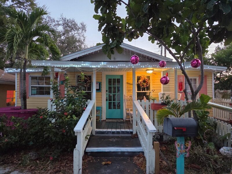 WonderWorks cottage decorated with string lights and ornaments in the evening
